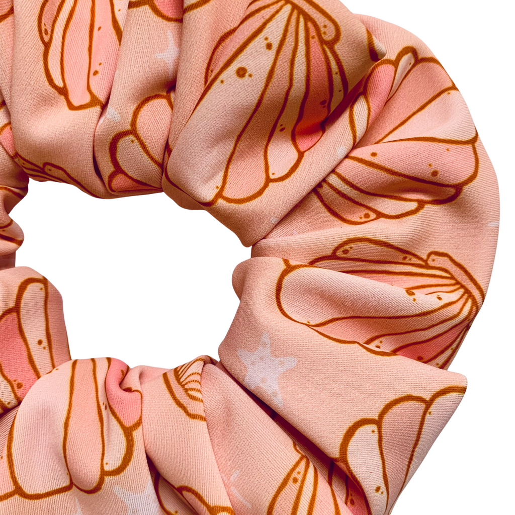 Pink swim scrunchie with shell pattern  on a white background