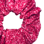 Pink printed sparkle swim scrunchie on a white background