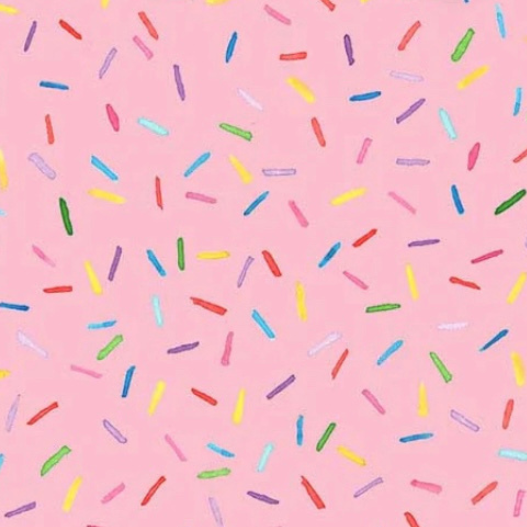 Colourful sprinkles pattern on a pink background