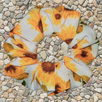 Sunflower patterned swim scrunchie on a stone surface
